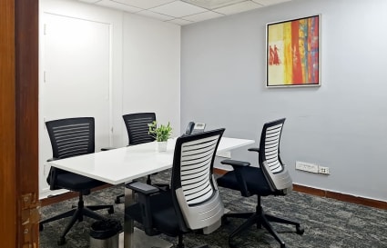 Modern coworking space with ergonomic chairs, natural light, and a vibrant decor.