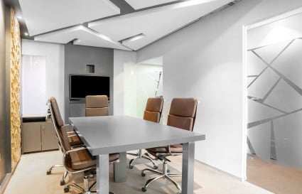 Sleek meeting area with a modern design and ample natural light, ideal for collaboration.