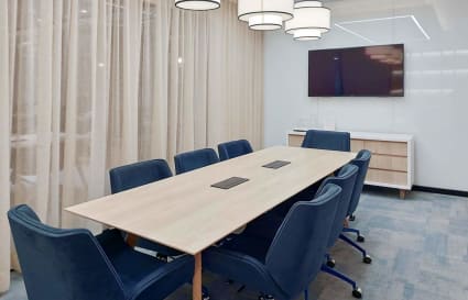 Modern conference room with cozy seating, elegant lighting, and advanced AV setup in मुंबई.