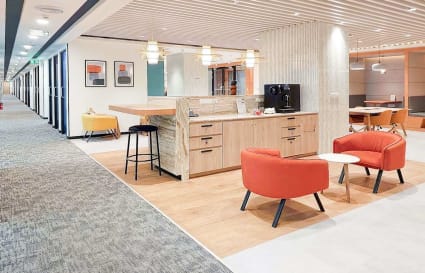 Modern coworking space in Mumbai with cozy seating, sleek decor, and a convenient coffee bar.