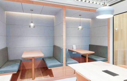 Modern coworking booths offer privacy and comfort in a stylish Mumbai office space.