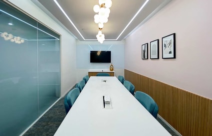Sleek meeting room with modern decor, ample seating, and advanced AV setup in Turbhe MIDC Road.