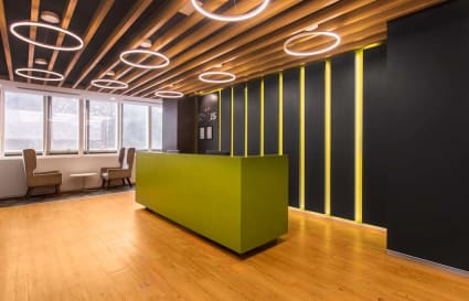 Modern coworking space with sleek design, vibrant lighting, and ample natural light.