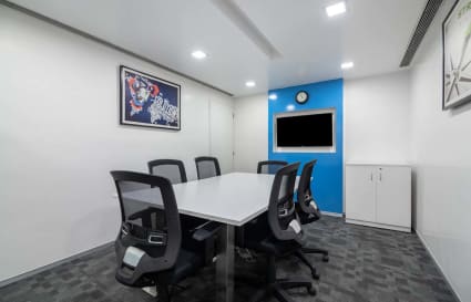 Modern meeting room in Sion-Trombay office, featuring sleek furniture and ample lighting.