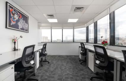 Bright, modern coworking space with ergonomic chairs and expansive city views. Ideal for productivity.