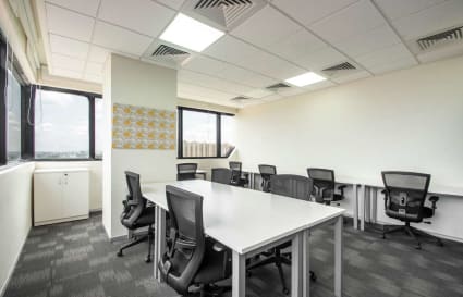 Modern coworking area with ergonomic chairs and natural lighting on Nallurhalli Road.
