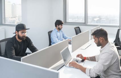 Modern coworking space with ample natural light and spacious workstations in Delhi's Phase 1.
