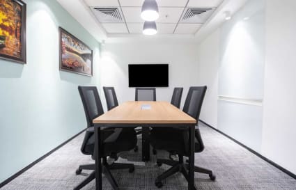 Modern meeting room with sleek design, optimal lighting, and seating for six in Delhi's Phase 1.