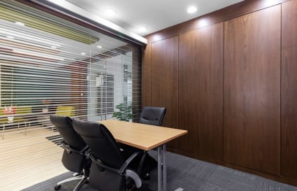 Modern coworking space with sleek wooden paneling and comfortable seating in Karnataka.