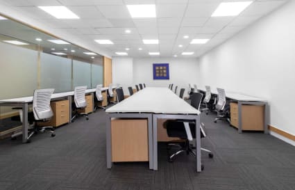 Spacious coworking area with ample seating, modern desks, and private offices. Ideal for collaboration.