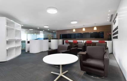 Modern coworking space with sleek furnishings and ample natural light, ideal for collaboration.