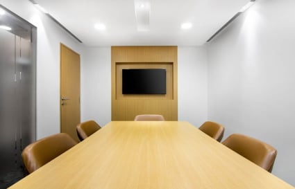 Modern meeting room with sleek design, ample seating, and a wall-mounted screen in Camac Street.