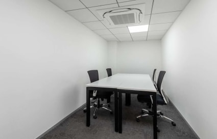Modern meeting room with sleek design, AC, and ergonomic chairs on Judges Bunglow Road.