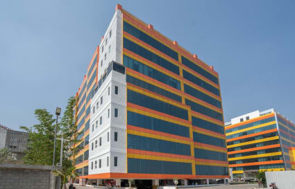 Vibrant coworking space on Nava India Road; modern exterior with ample natural light.