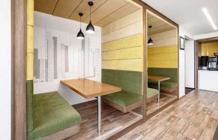 Stylish booth seating with urban decor, ideal for focused work or collaborative meetings.
