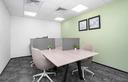 Modern coworking space with sleek desks, ergonomic chairs, and greenery accents for a productive environment.