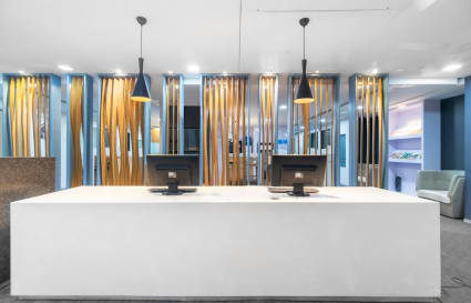 Modern coworking space with sleek reception, stylish lighting, and vibrant decor on Annie Besant Road.