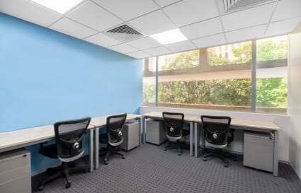 Bright coworking space with ergonomic chairs, spacious desks, and natural light. Ideal for productivity.