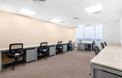 Spacious coworking area with individual desks and ergonomic chairs, ideal for productive work.