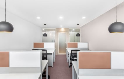 Bright, modern coworking space with sleek workstations and stylish lighting in South Phase.