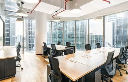 Bright coworking space with modern furnishings and panoramic city views in Robinson Road, Singapore.