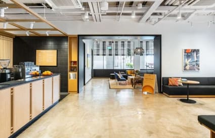 Modern coworking space with sleek seating, natural light, and inviting collaborative areas.