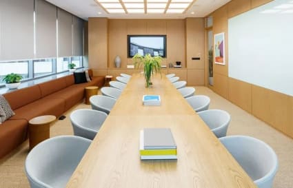 Sleek meeting room with ample seating, natural light, and modern finishes. Ideal for collaboration.