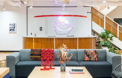 Vibrant coworking space with modern decor on Ayala Avenue, featuring a cozy seating area and stylish accents.