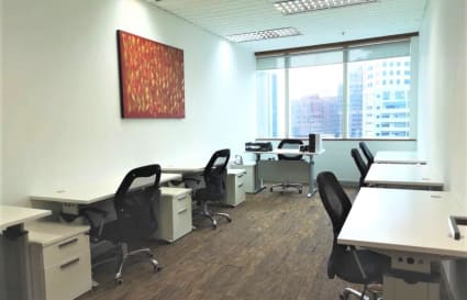 Bright, spacious coworking area with modern desks, ergonomic chairs, and city views.