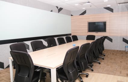 Modern meeting room with ample seating, large conference table, and sleek design elements.