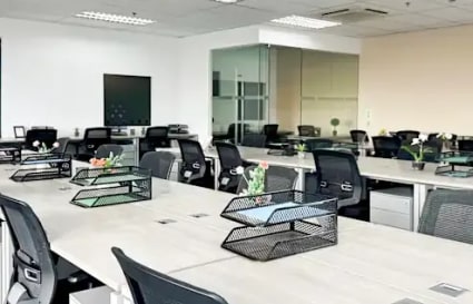 Modern coworking space in Fort Bonifacio with open desks, natural light, and sleek decor.