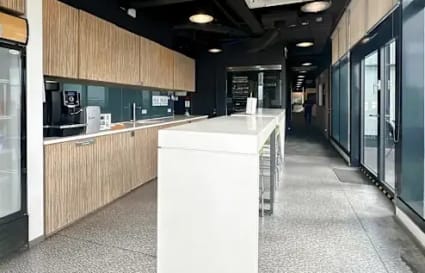 Modern coworking kitchen with sleek countertops and ample natural light in Fort Bonifacio.