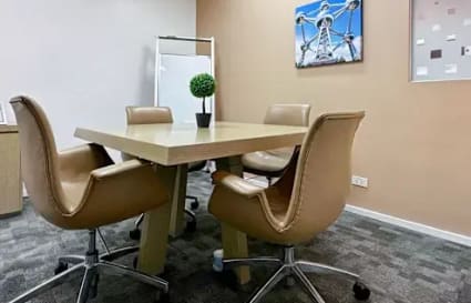 Modern meeting room with sleek chairs, vibrant decor, and a collaborative atmosphere.