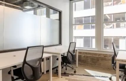 Modern coworking space with natural light, sleek furnishings, and collaborative layout in Taguig.