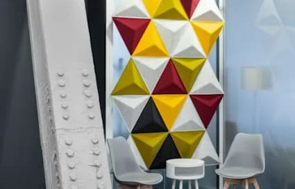 Colorful, modern meeting area with geometric wall art and sleek seating in Taguig coworking space.