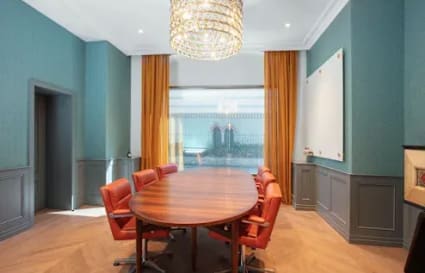Elegant meeting room in Taguig's flexible coworking space featuring a long table and stylish chairs.