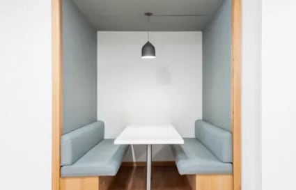 Cozy meeting nook with modern lighting and seating in Taguig coworking space. Ideal for collaboration.