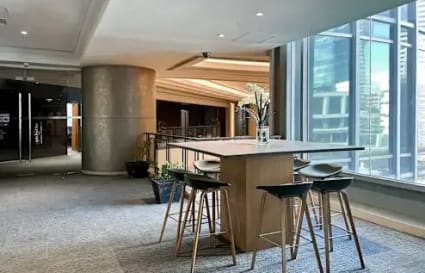Modern coworking space in Makati with high stools, natural light, and a collaborative vibe.