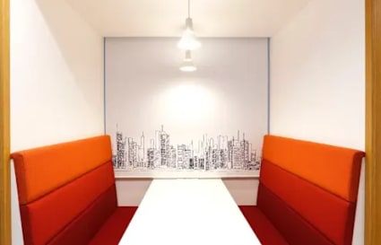 Cozy alcove with city skyline backdrop, perfect for focused work or meetings.