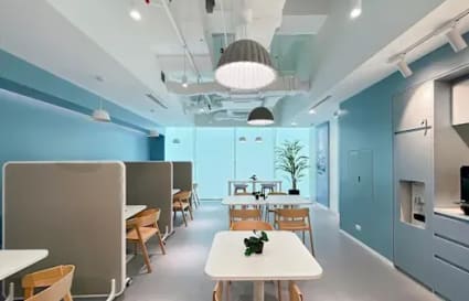Bright coworking space with modern design, private booths, and ample natural light.