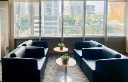 Bright Cebu coworking space with modern seating, natural light, and urban views. Ideal for collaboration.