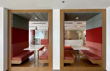 Modern coworking pods with vibrant seating on Ayala Avenue, ideal for collaborative work.
