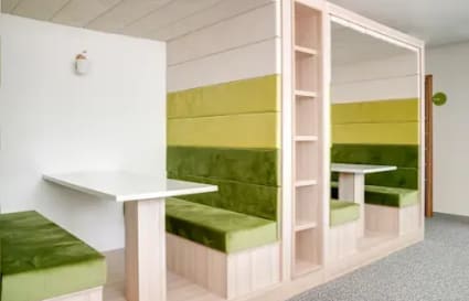 Modern coworking booths with plush seating, ideal for focused work and collaboration.
