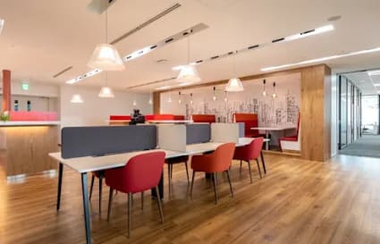 Modern coworking space with vibrant seating, open layout, and ample natural light.