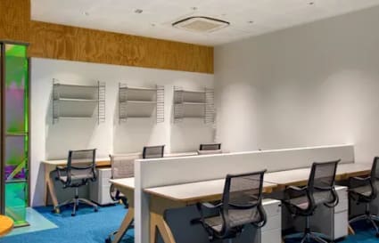 Modern coworking space in Hyderabad with ergonomic chairs, ample lighting, and stylish finishes.
