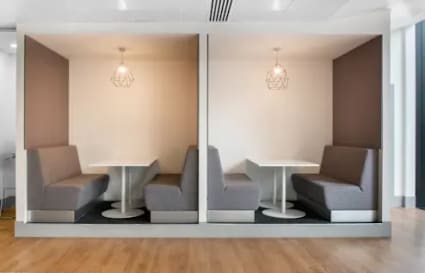 Modern coworking booths with stylish lighting, perfect for focused work in Hyderabad.