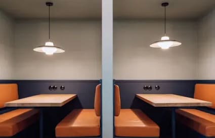 Modern booths with warm lighting, ideal for focused work or team meetings in a flexible workspace.