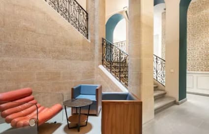 Stylish coworking lounge with modern seating and elegant stone accents in Hyderabad. Ideal for collaboration.