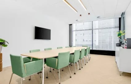 Modern conference room with natural light, sleek furnishings, and ample seating for collaboration.