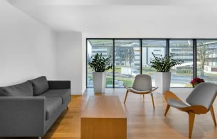 Modern lounge area with natural light, stylish seating, and scenic window views. Perfect for collaboration.